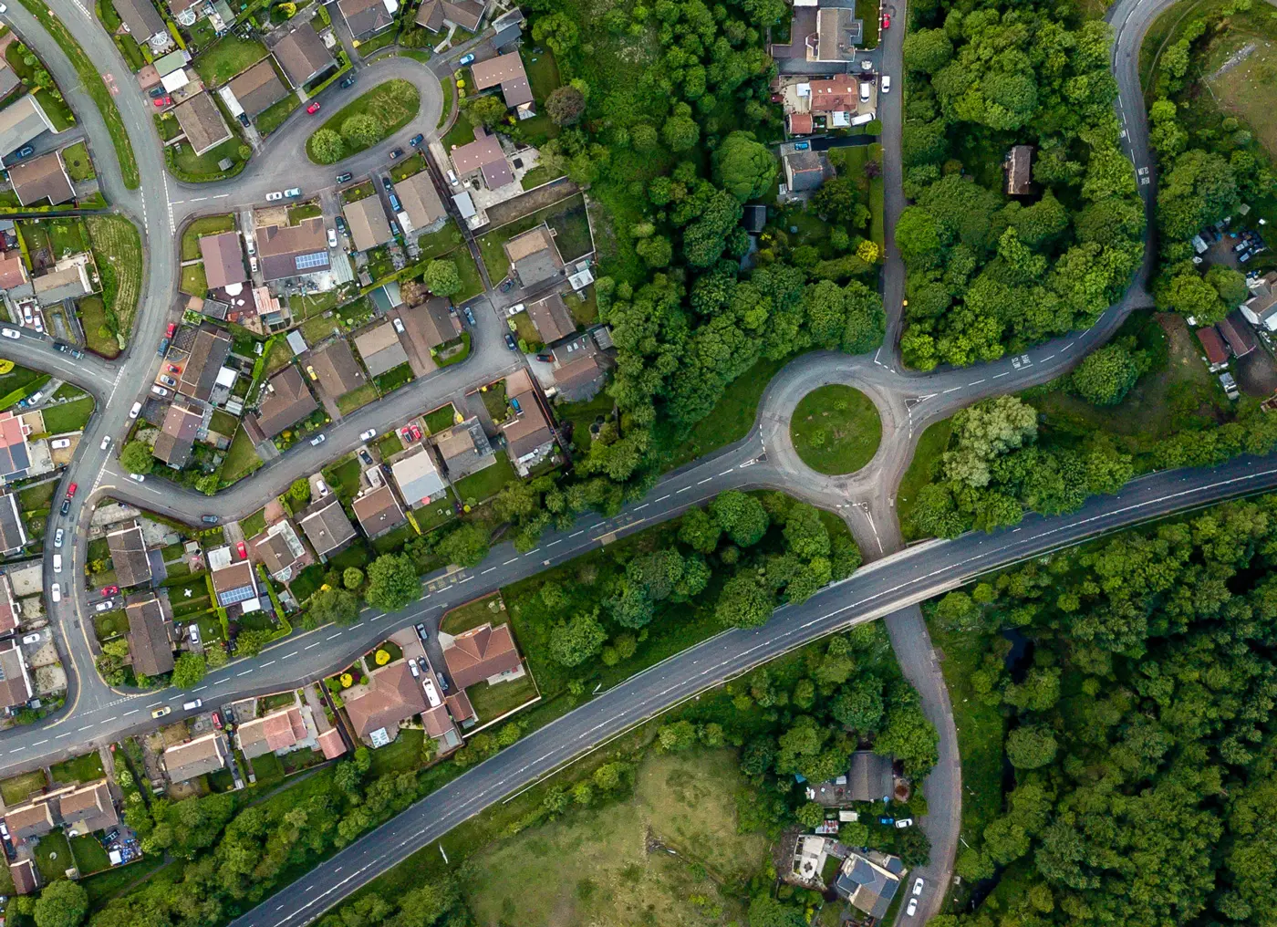 Aerial View of neighborhood featuring a traffic circle and highway overpass